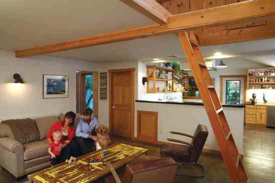 
James made the coffee table in the front room from an antique door. The handmade ladder leads to a storage loft.
